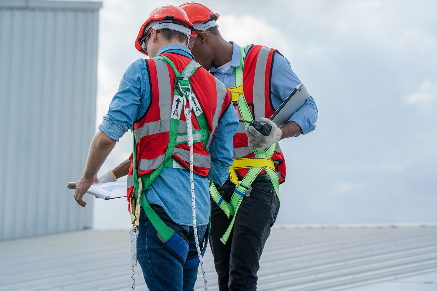 Construction worker wearing safety harness and safety line,Equipment of industrial worker high place of building,Climbing equipments before starting job,Rope laborer access.