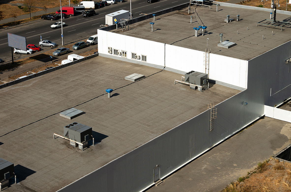 View of the roof of a commercial building in the middle of the city.