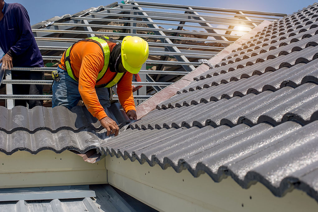 Roof repair,  construction worker repairing roof,replacing gray