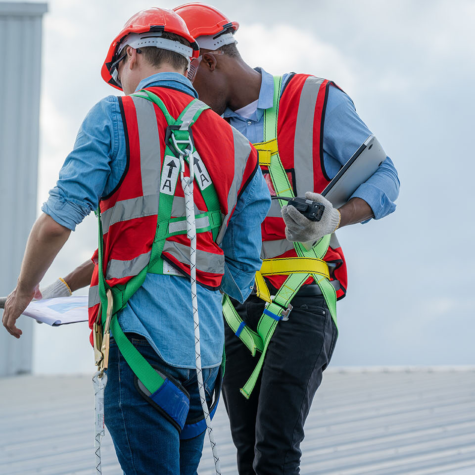 Construction worker wearing safety harness and safety line,Equipment of industrial worker high place of building,Climbing equipments before starting job,Rope laborer access.